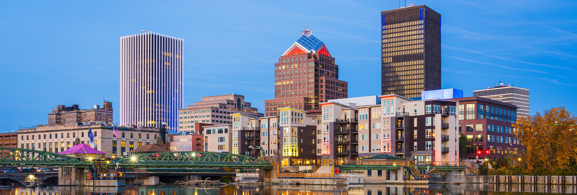 Downtown Rochester, New York skyline along the Genesee River at dusk